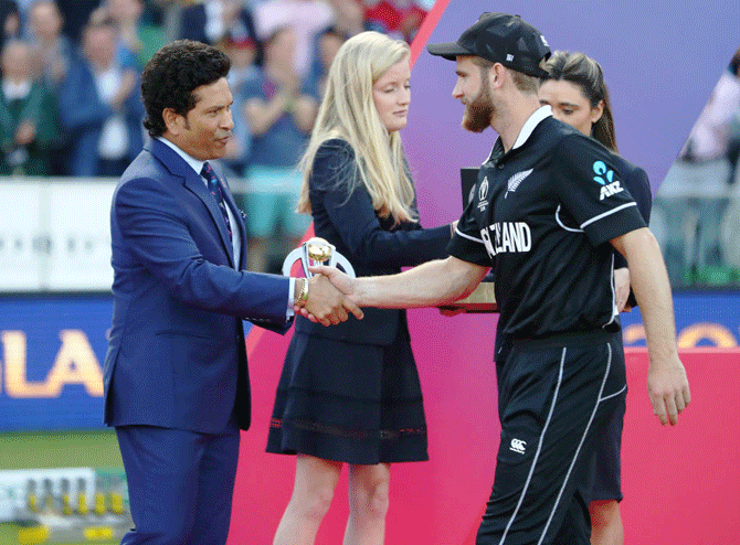 New Zealand captain Kane Williamson receives the player of the tournament award from Sachin Tendulkar at the presentation ceremony after the World Cup final at Lord's Cricket Ground on Sunday