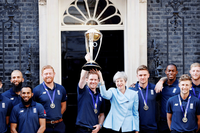 England's cricket captain Eoin Morgan and Britain's Prime Minister Theresa May with the trophy as they pose with the team outside number 10 at Downing Street in London 