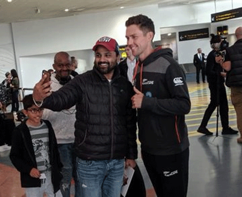 New Zealand's Trent Boult obliges a fan for a selfie on arrival in Auckland on Thursday