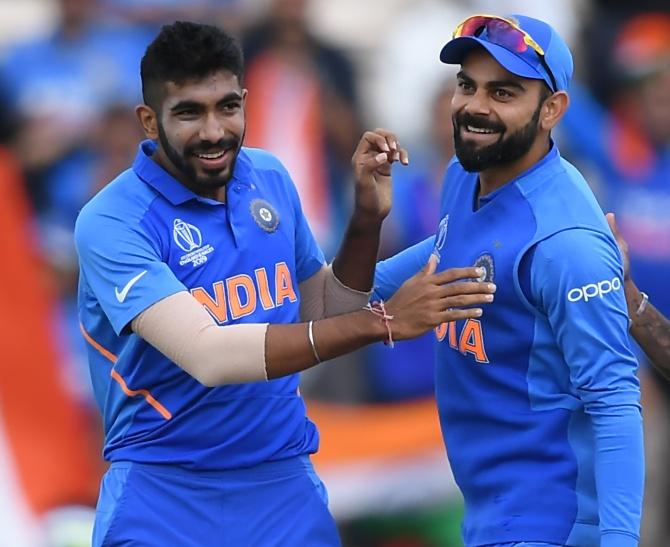 Jasprit Bumrah and Virat Kohli celebrate Quinton De Kock's wicket at The Hampshire Bowl in Southampton on June 5, 2019.