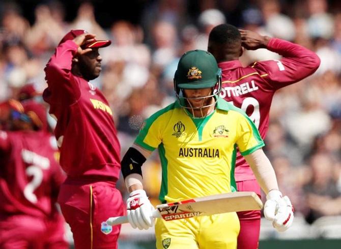 Sheldon Cottrell celebrates with his West Indies teammates after dismissing David Warne