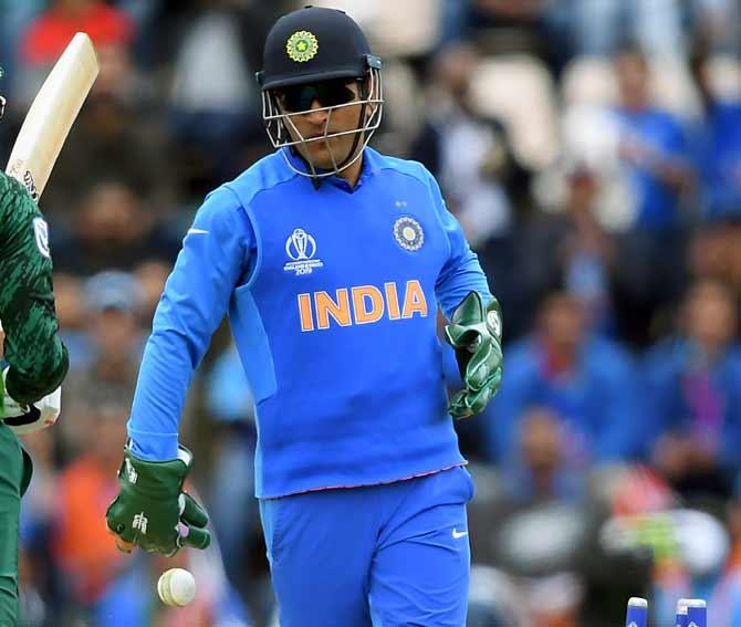 IMAGE: The regimental dagger insignia of the para forces visible on Mahendra Singh Dhoni's wicket-keeping gloves during the World Cup match against South Africa. Photograph: Alex Davidson/Getty Images