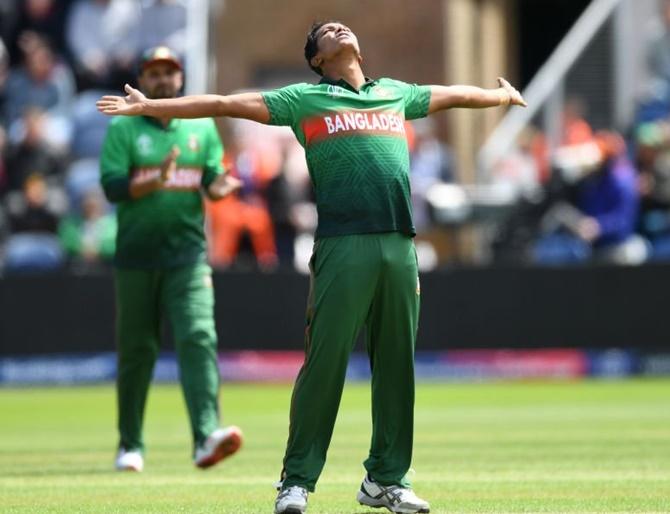 Bangladesh's Mohammad Saifuddin celebrates the wicket of England's Jos Buttler