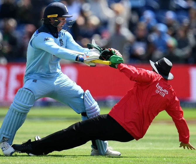 Jason Roy collides with umpire Joel Wilson as he prepares to celebrate his century against Bangladesh in Cardiff on June 8