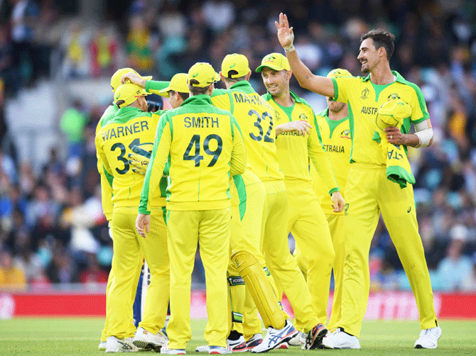 Australia's Mitchell Starc celebrates with teammates after taking the wicket of Sri Lanka's Thisara Perera