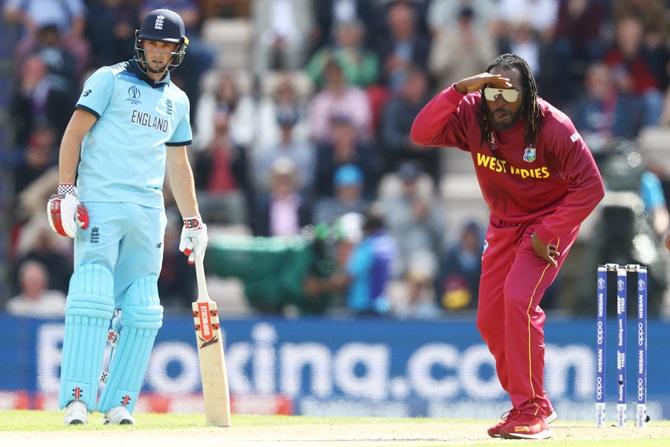 Chris Gayle looks with comic aggression following a delivery to Joe Root as Chris Woakes backs up during their match in Southampton on June 15