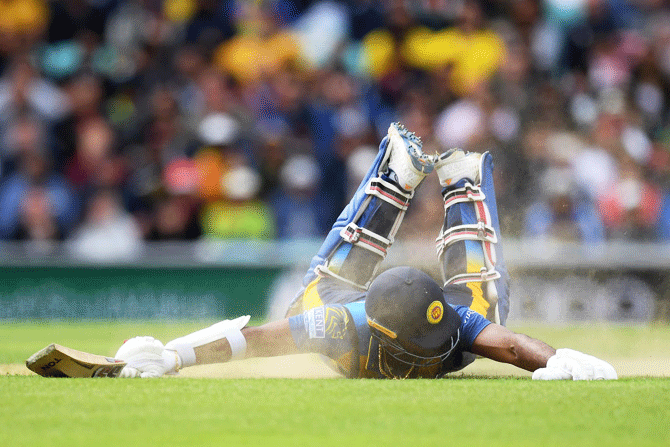 Sri Lanka's Kusal Perera dives to make his ground