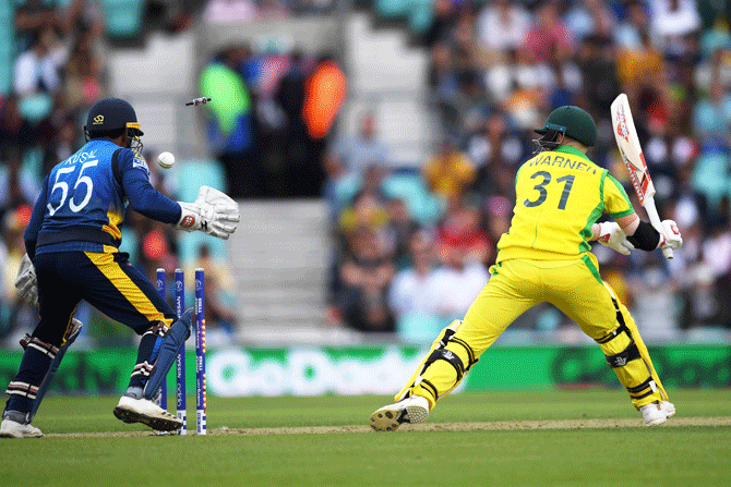 Australia's David Warner is bowled by Sri Lanka's Dhananjaya de Silva