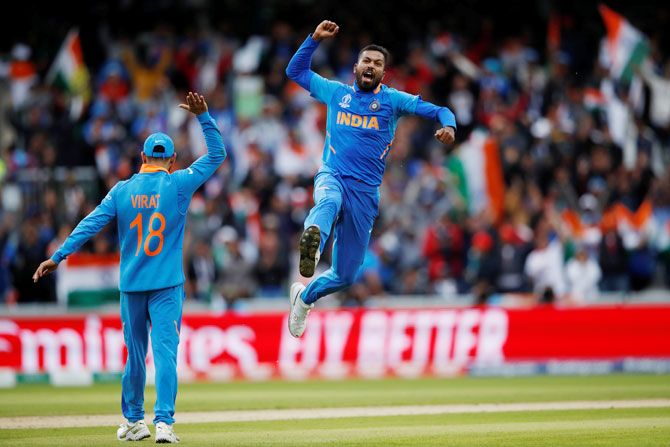 India's Hardik Pandya celebrates taking the wicket of Pakistan's Shoaib Malik