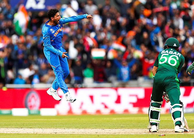 Kuldeep Yadav, left, celebrates after dismissing Babar Azam. Photograph: Lee Smith/Action Images via Reuters