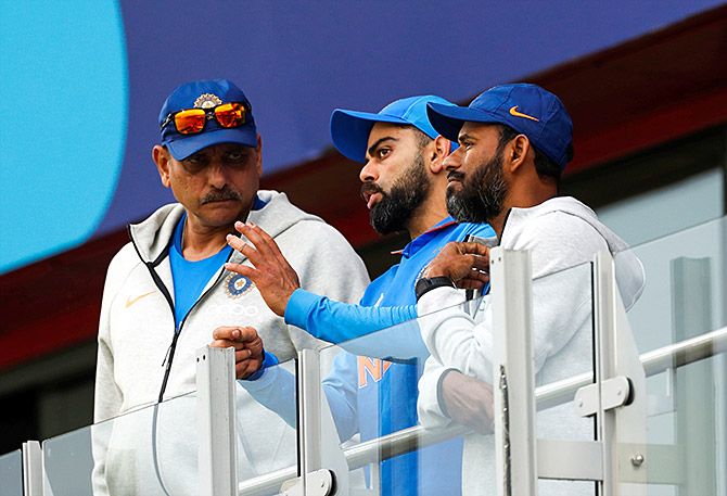 Head Coach Ravi Shastri and Captain Virat Kohli confer after rain stopped play during the India-Pakistan game at Old Trafford, June 16, 2019. Photograph: Lee Smith/Action Images via Reuters