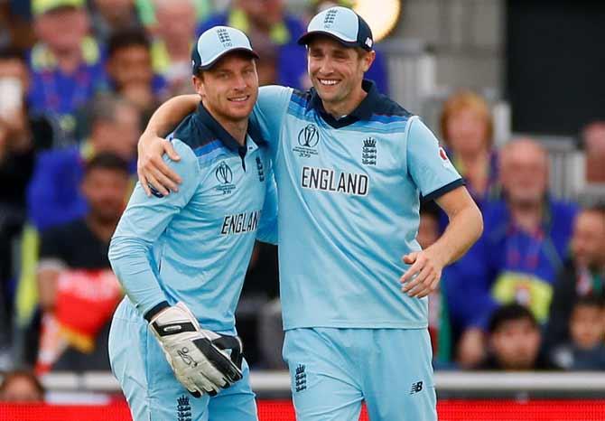 Jos Buttler and Chris Woakes celebrate the dismissal of Gulbadin Naib