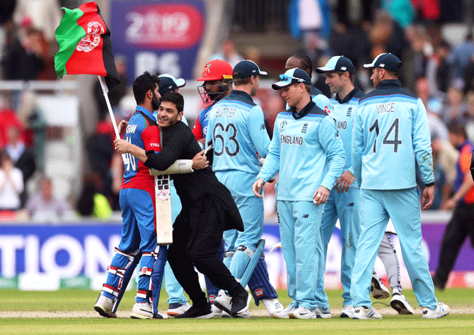 An Afghanistan fan runs on to the pitch after the match on Tuesday