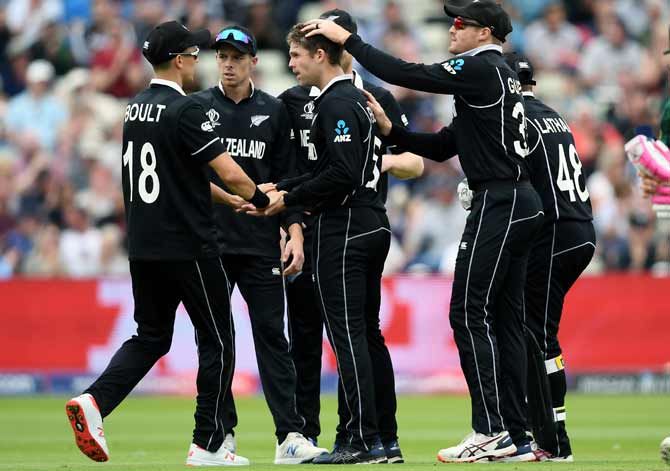 Lockie Ferguson, centre,  (is congratulated by teammates after taking  the wicket of Faf du Plessis