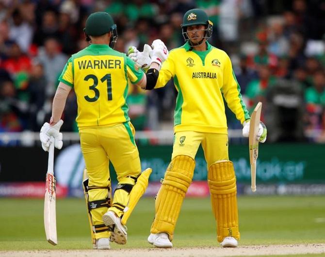 Usman Khawaja is congratulated by David Warner after scoring 50 against Bangladesh on Thursday