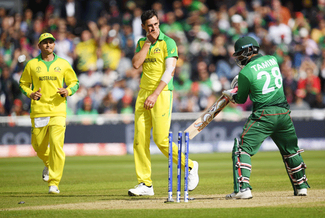 Australia'S Mitchell Starc celebrates after bowling out Bangladesh's Tamim Iqbal