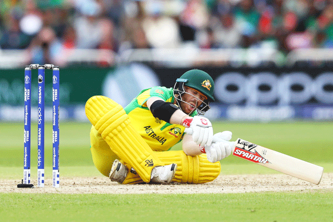 Australia's David Warner is floored by a delivery from Bangladesh's Rubel Hossain during their match on June 21