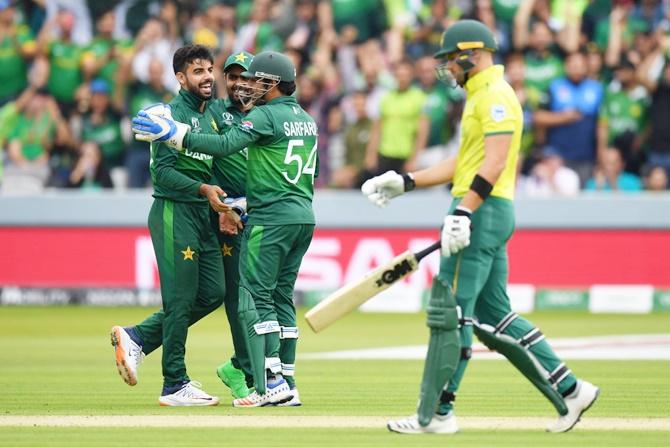 Shadab Khan celebrates with Sararaz Ahmed after dismissing Aiden Markram.