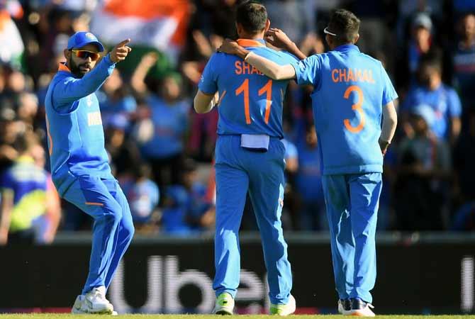 Mohammed Shami, centre, celebrates with Virat Kohli, left, and Yuzvendra Chahal after dismissing the well-set Mohammad Nabi during India's game against Afghanistan, June 22, 2019. Photograph: Alex Davidson/Getty Images