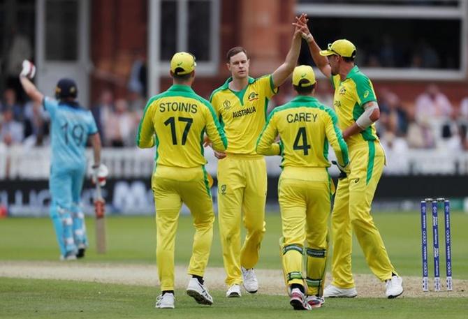 Jason Behrendorff celebrates with teammates after taking the wicket of England's Moeen Ali