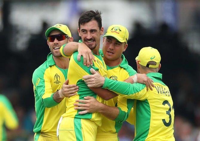 Mitchell Starc is congratulated by his Australia teammates after taking the wicket of England's Eoin Morgan.
