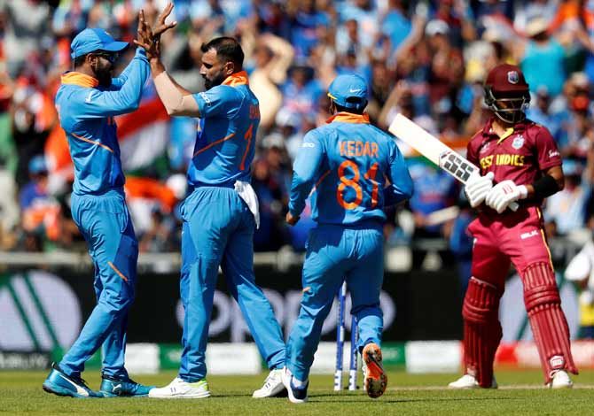 Mohammed Shami celebrates with teammates after scalping the wicket of West Indies' Shai Hope on Thursday. Shami picked up four wickets against West Indies in India's 125-run victory.
