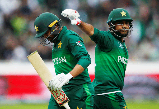 Pakistan's Haris Sohail is tapped on the head by Sarfaraz Ahmed as he walks off after losing his wicket