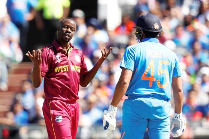  India's Rohit Sharma watches helplessly as West Indies' Kemar Roach celebrates his dismissal in Thursday's World Cup match.