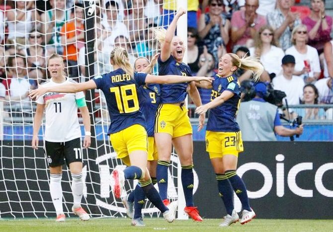Stina Blackstenius celebrates with team mates scoring Sweden's second goal