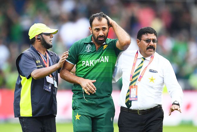 Pakistan's Wahab Riaz is escorted off the field after the Group Stage match against Afghanistan at Headingley on in Leeds on Saturday