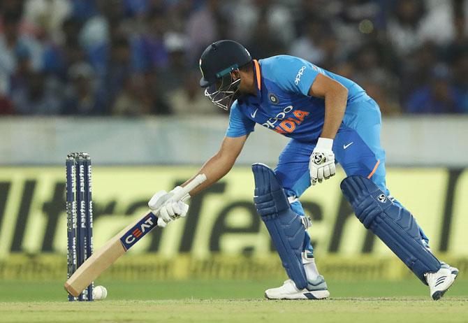 Rohit Sharma stops the ball from rolling towards the stumps