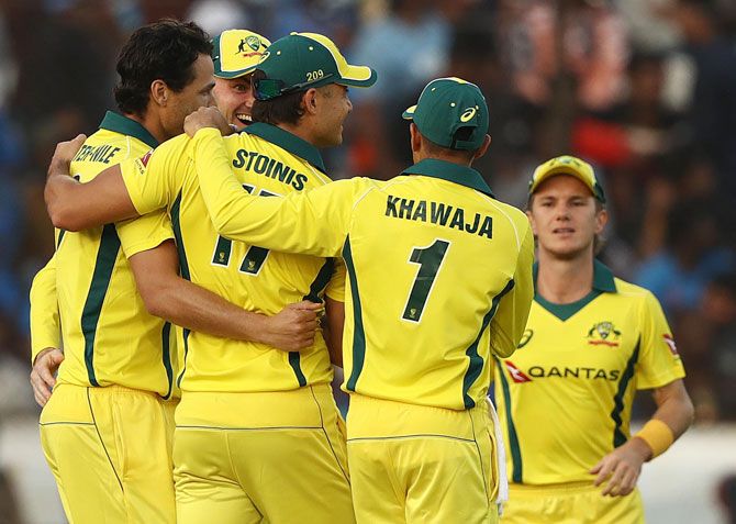 Nathan Coulter-Nile celebrates with his Australian teammates after dismissing Shikhar Dhawan