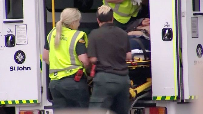 Emergency services personnel transport a stretcher carrying a person at a hospital, after reports that several shots had been fired, in central Christchurch in this still image taken from video on Friday