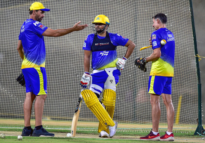 Chennai Super Kings head coach Stephen Fleming, left, with batting coach Michael Hussey, right, and Suresh Raina