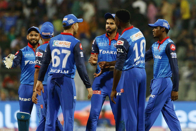 Delhi Capitals players celebrate the fall of a wicket
