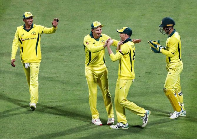 Australia players celebrate the fall of a Pakistan wicket during the 4th ODI in Dubai on Friday