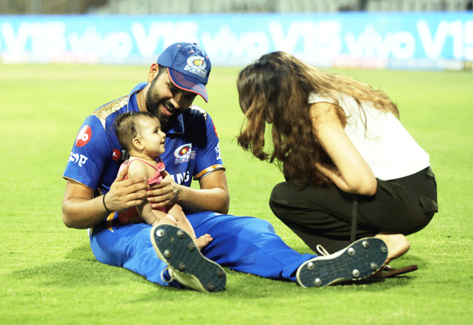 Mumbai Indians captain Rohit Sharma plays with his daughter Samaira as his wife Ritika Sajdeh joins in the fun