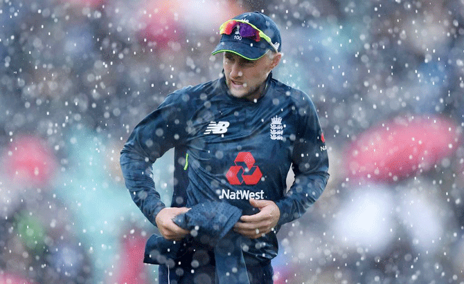 England's Joe Root leaves the field as rain stops play during the first One Day International between England and Pakistan at The Kia Oval in London on Wednesday