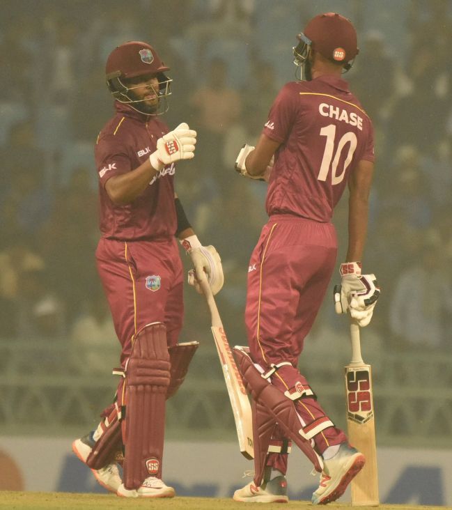 West Indies' Roston Chase and Shai Hope celebrate their win over Afghanistan in the 1st ODI in Lucknow on Wednesday