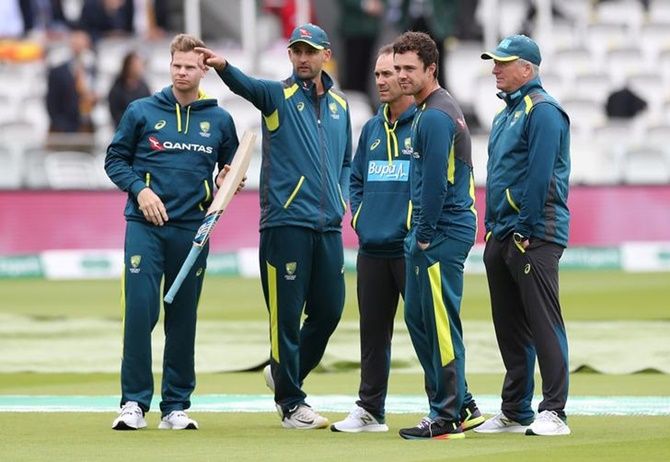 Australia's head coach Justin Langer chats with Steve Smith, Nathan Lyon and former Australia captain Steve Waugh, right, at Lord's Cricket Ground, London, during the second Ashes Test, in August