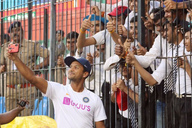 Mayank Agarwal takes a selfie with deaf and mute after Day 2's play at the Holkar Cricket Stadium, Indore on Friday