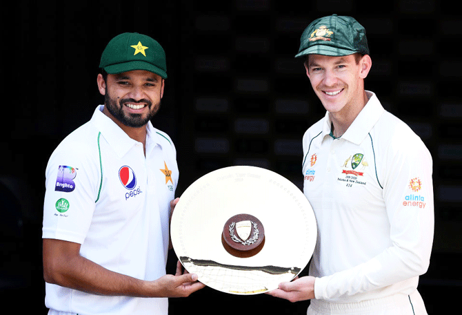 Pakistan captain Azhar Ali and Australian captain Tim Paine pose with the trophy ahead of the 1st Test between Australia and Pakistan at The Gabba in Brisbane on Wednesday
