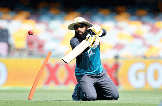 Pakistan Coach Misbah-ul-Haq gives his players catching practice during a nets session at The Gabba on Wednesday