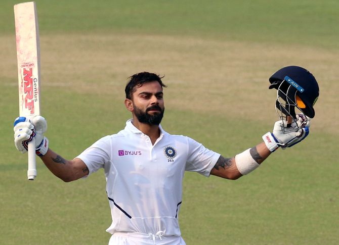 India captain Virat Kohli celebrates after completing his century on Day 2 of the 2nd Test at Eden Gardens in Kolkata on Saturday