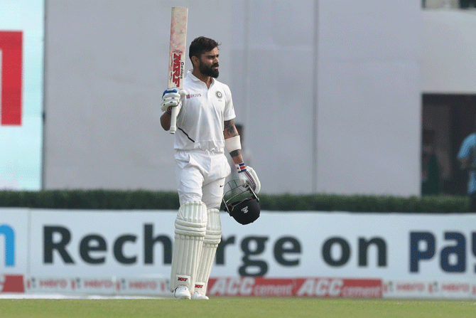 India captain Virat Kohli celebrates on completing his century on Day 2 of the 2nd Test between India and Bangladesh at the Eden Gardens in Kolkata on Saturday
