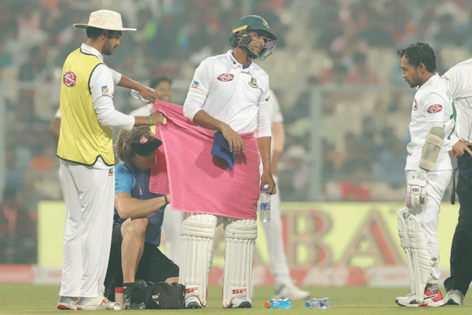 Bangladesh's Mahmudullah gets treatment from the physio after a hamstring injury