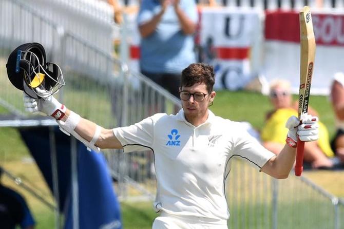 New Zealand's Mitchell Santner celebrates his century on Sunday, Day 4 of the first Test against England, at Bay Oval, Mount Maunganui.