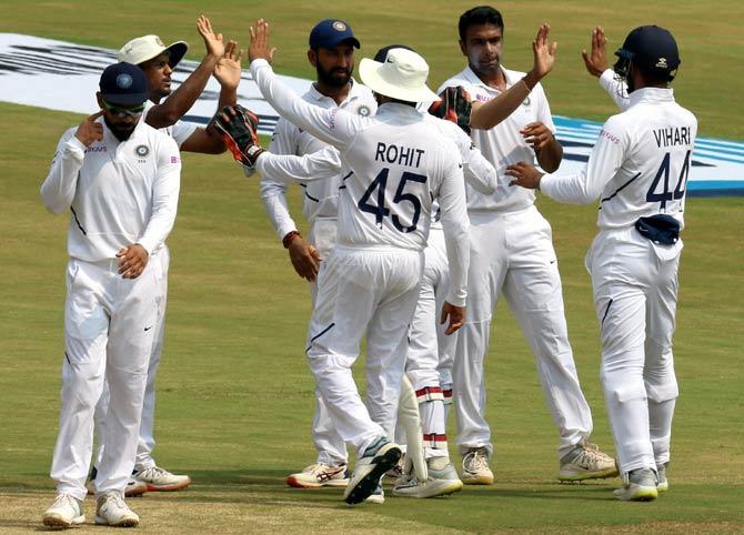 India's players celebrate after Ravichandran Ashwin dismissed Keshav Maharaj