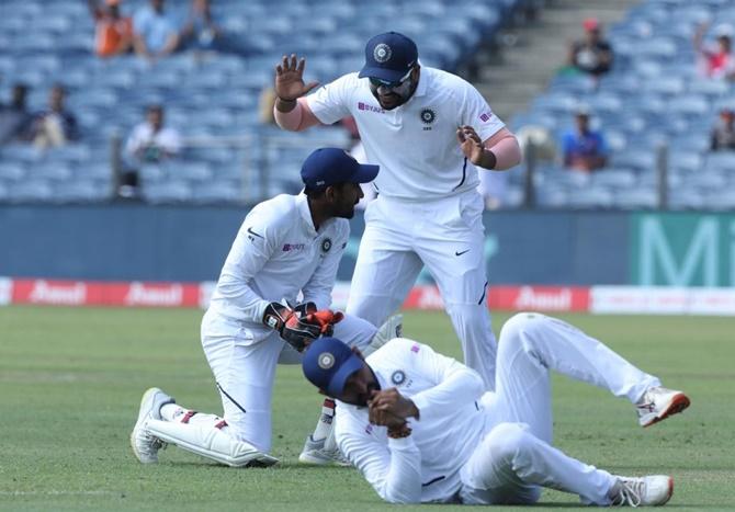 Wriddhiman Saha takes an acrobatic catch to dismiss Theunis de Bruyn. 