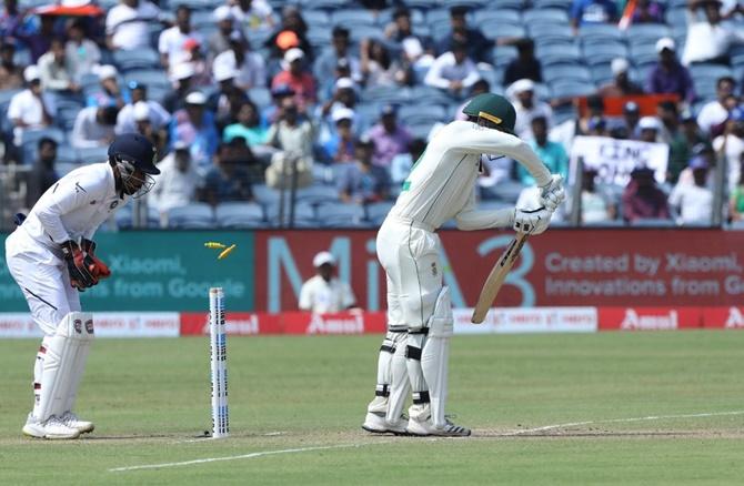 Quinton de Kock is bowled by Ravichandran Ashwin